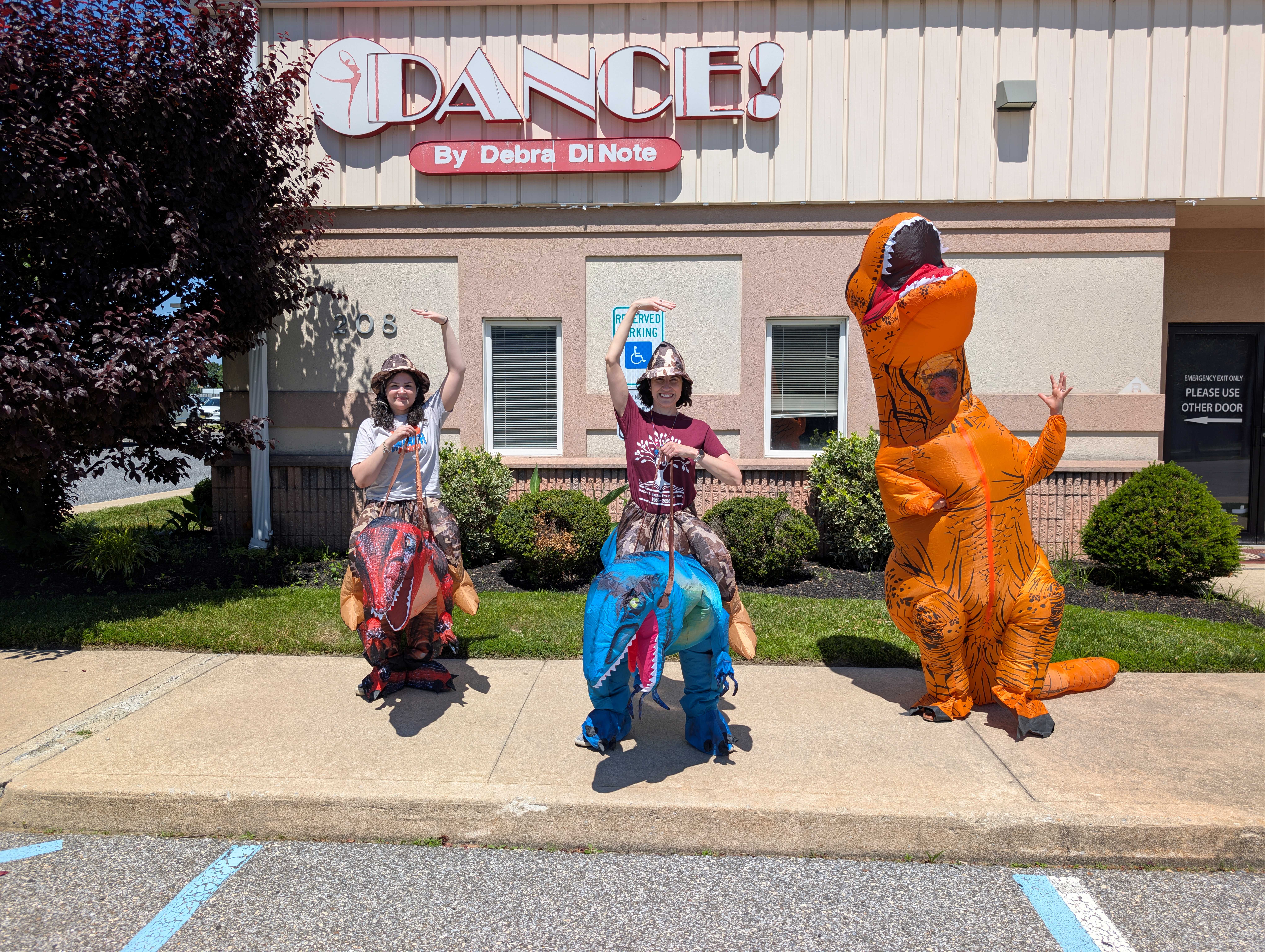 Rebeccasaurus, Stephasaurus, and Sarasaurus in front of one of the library's former locations