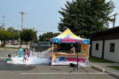 Mr. Foamtastic's stand as it unleashes foam into a crowd of children