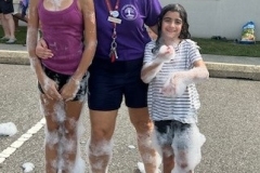 Youth Services Librarian Sara Figueroa poses for a photo with young patrons