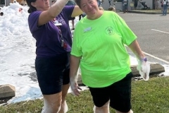 Youth Services Librarian Sara Figueroa places foam on the head of Library Director Sheila Mikkelson