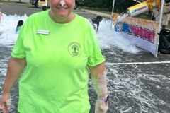 Library Director Sheila Mikkelson with foam on her head